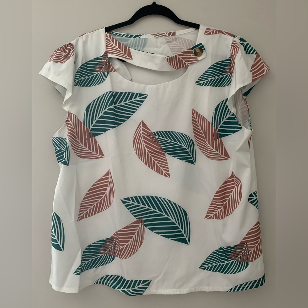 Leaf print blouse with button collar detail.